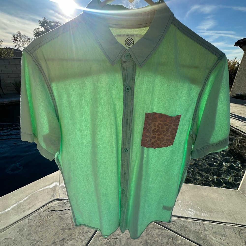 Teal green button up pocket tee shirt 
Medium